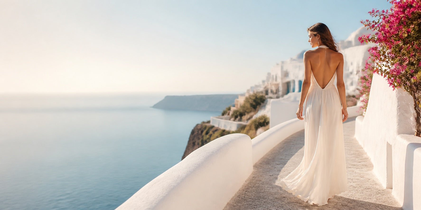 Woman wearing an ivory summer dress overlooking the Aegean Sea